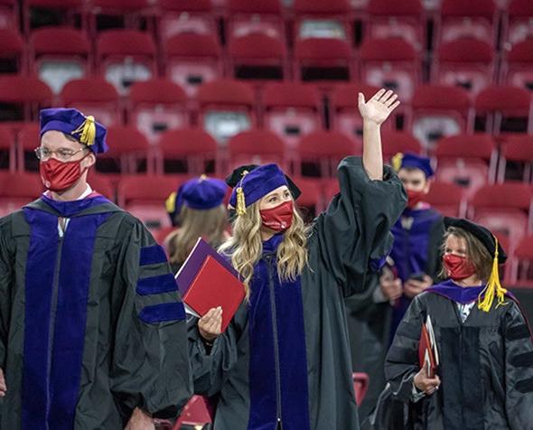 Student waving during law commencement